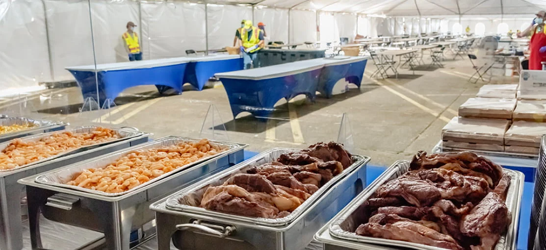 Warm food Is prepared inside a dining tent.