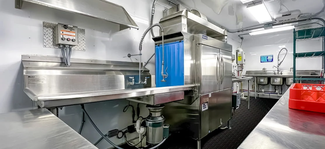 Temporary kitchen equipment inside a DRG dining tent.