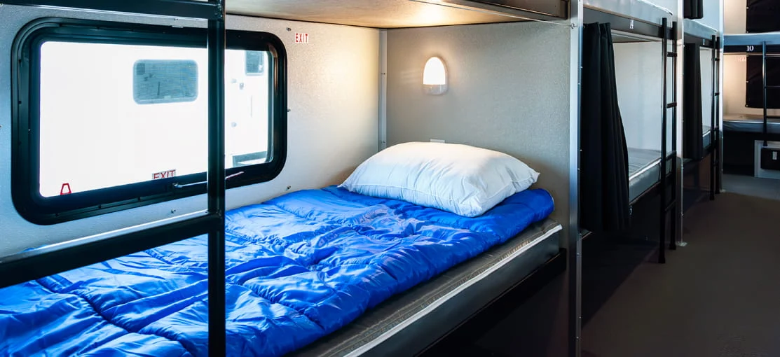 Sleeping quarters inside a housing trailer.