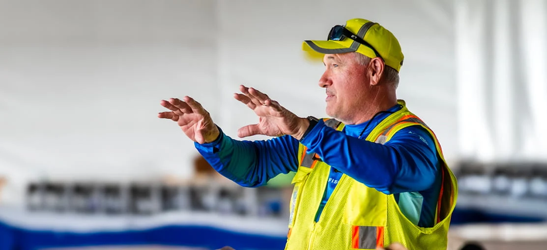 A DRG employee speaks at a training center.