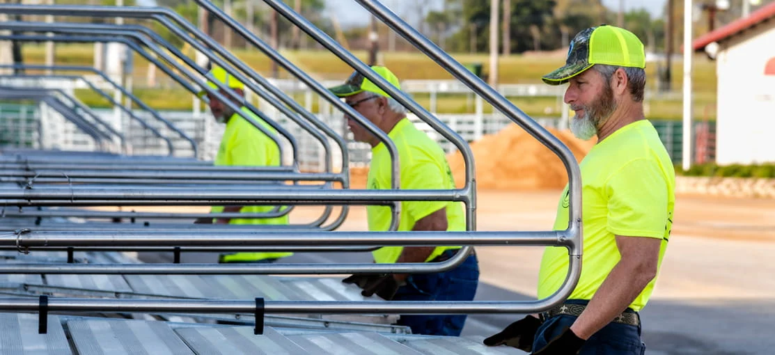 DRG employees deploy steps extending from mobile equipment trailers.