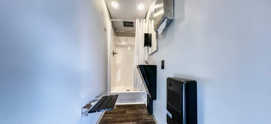 Shower stall inside a mobile restroom trailer.