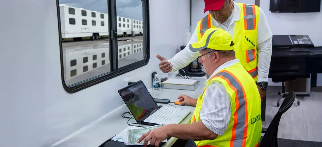 A DRG command center employee reviews information on a laptop.