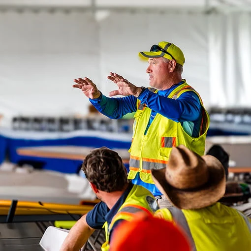 A DRG employee speaks at a training center.