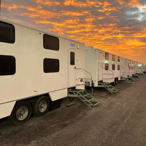 A row of white mobile command centers.