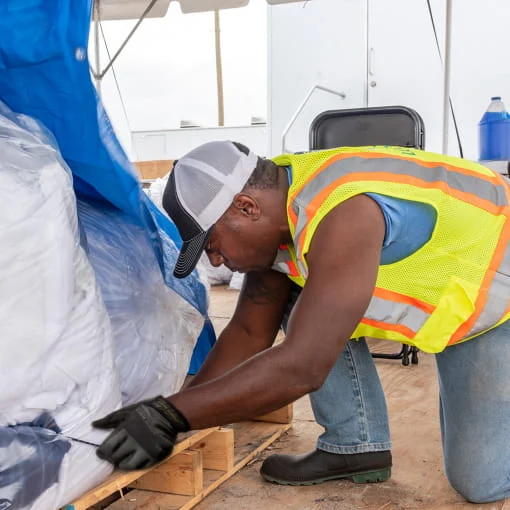 A DRG employee sets up equipment at a base camp.